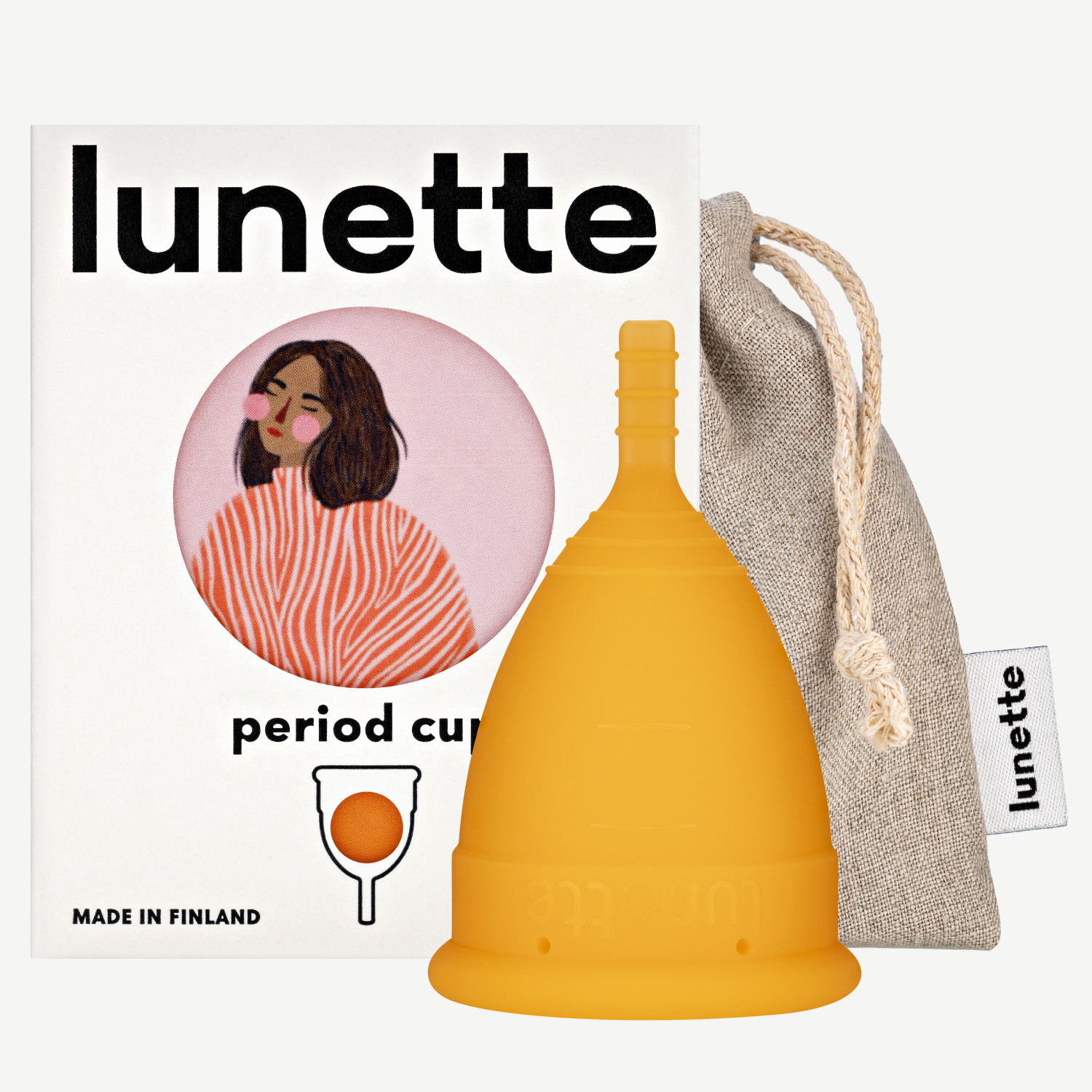 An orange Lunette period cup displayed alongside its packaging box with a floral design and a linen storage pouch. The box includes the text 'period cup', 'made in Finland', and the brand name 'Lunette'.